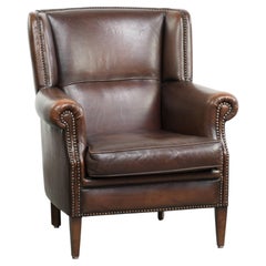 Subtle sheepskin wingback armchair with a deep cognac colour
