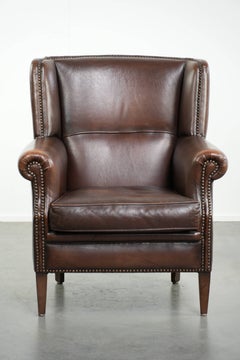 Subtle sheepskin wingback armchair with a deep cognac colour