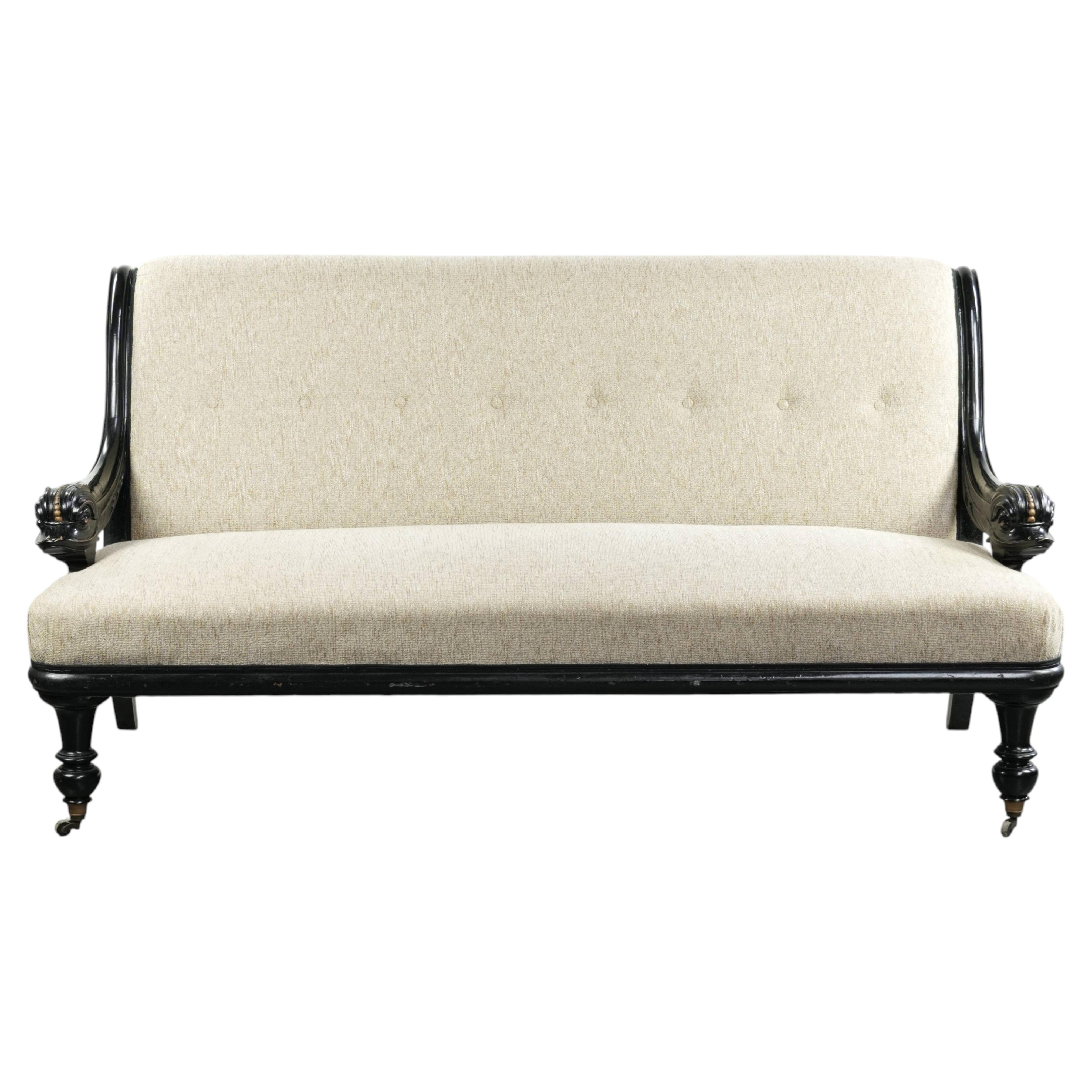 French sofa from the 19th century in Empire style with detailed armrests