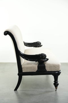French sofa from the 19th century in Empire style with detailed armrests