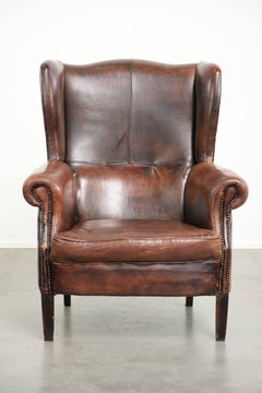 Vintage sheepskin wingback armchair in a deep brown colour finished