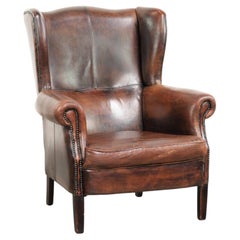 Vintage sheepskin wingback armchair in a deep brown colour finished