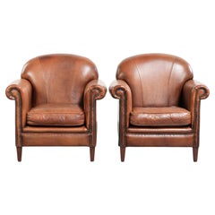 Set of two vintage sheepskin armchairs finished with decorative nails
