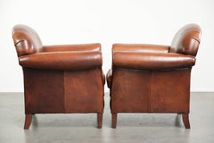 Set of two vintage sheepskin armchairs finished with decorative nails