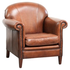 This vintage sheepskin armchair offers comfortable seating and is finished with