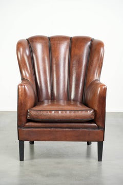 Unique sheepskin armchair with warm deep colours finished with black piping