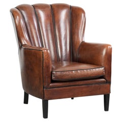 Unique sheepskin armchair with warm deep colours finished with black piping