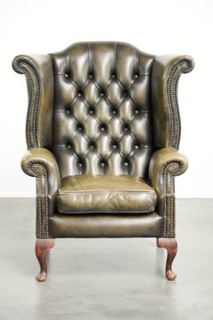 Characterful green cow leather Chesterfield wingback armchair in English style