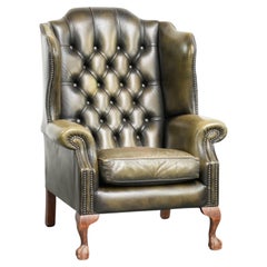 Vintage cowhide leather Chesterfield wingback armchair in a green colour