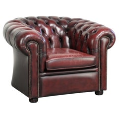 Chic lived-in English chesterfield club armchair in a timeless red colour