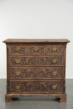 Richly carved English oak chest of drawers from the 18th century