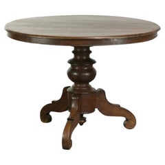 Subtle round rustic wooden dining table with a beautiful appearance