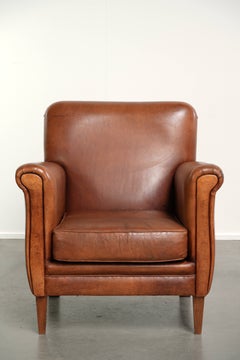 Sturdy vintage sheepskin armchair with a beautiful cognac colour