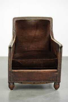 Art Deco design armchair finished in velvet and fitted with decorative nails