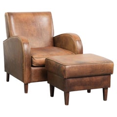 Set of a sheepskin armchair and ottoman finished with matching piping