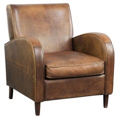 Sheepskin armchair in a light cognac colour with matching piping