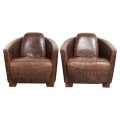 Set of 2 cowhide Aviator design armchairs in a warm brown colour