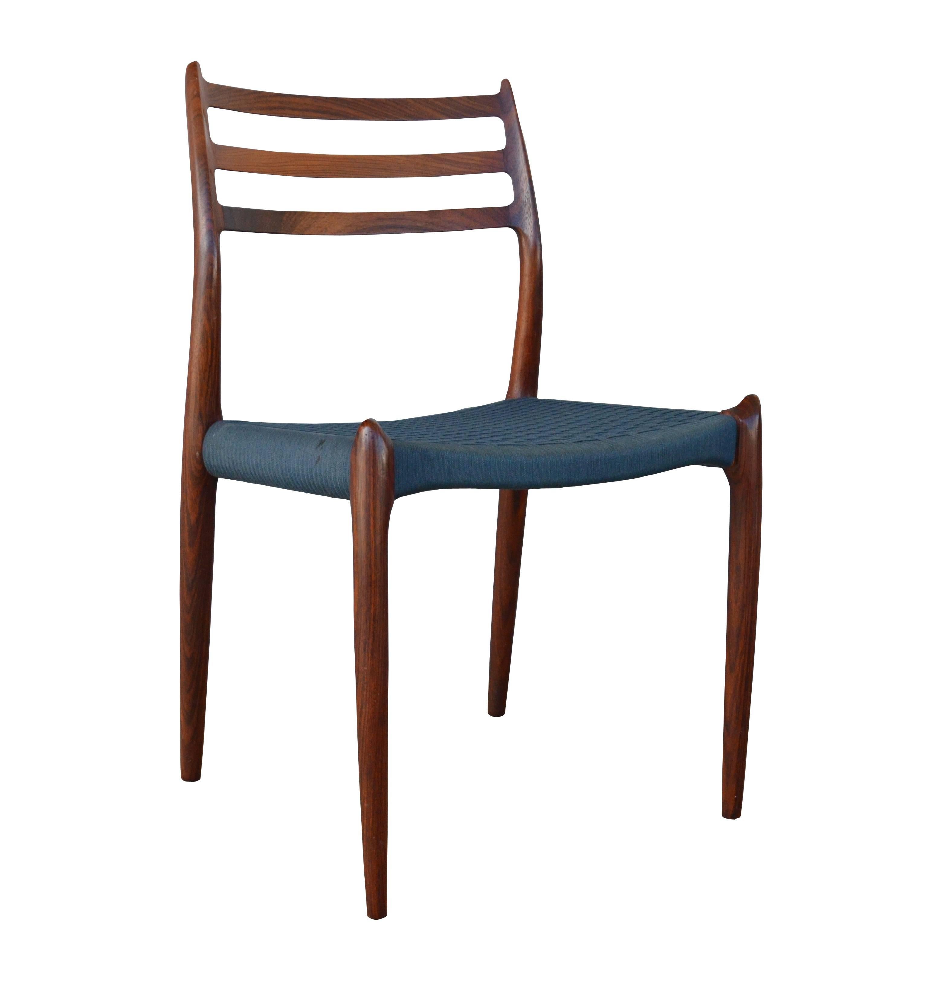 Stunning set of six rosewood dining chairs by Danish master Niels Moller. Chairs are in excellent condition and still retain the original wool cord seats which are a beautiful shade of deep blue/green. This unique color works very well with the