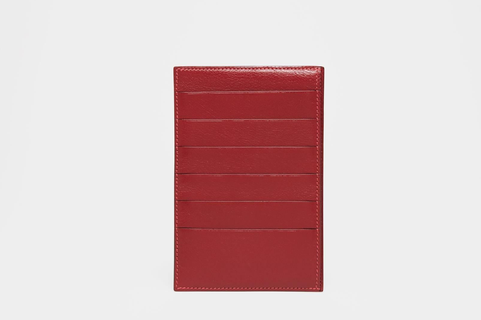 A box calf cherry red leather wallet by Hermès. This is the finest example of a wallet that money can buy. The make is what one comes to expect from the best leather makers in the world. This style of wallet is no longer in the line from Hermès.