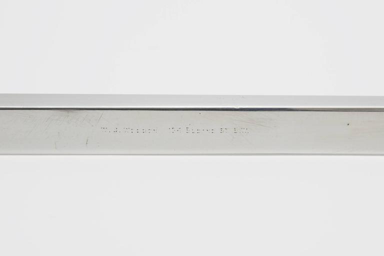 A sterling silver and hand engraved ruler and paper weight. This very clean and elegant desk accessory is the perfect gift for a draftsman, architect or designer. Made in a long rectangle, hollow cube shape the piece can be used for measuring, or