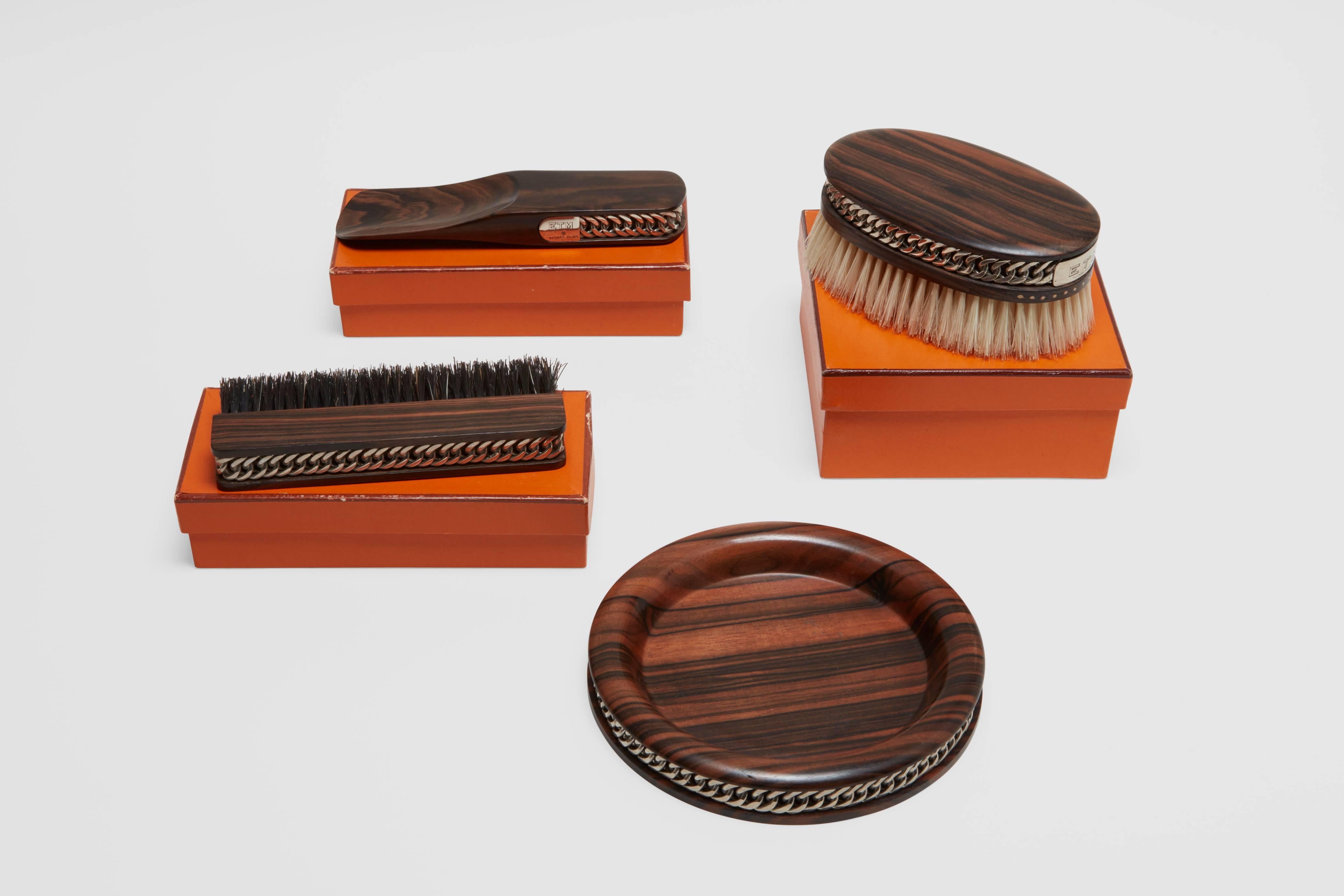 A banded Macassar ebony wood and silver plated brass set of gentleman's dressing table accessories. This set is one of the finest ever made, and was design by one of the most sought after designers in the world; Paul Dupré-Lafon.

This set was