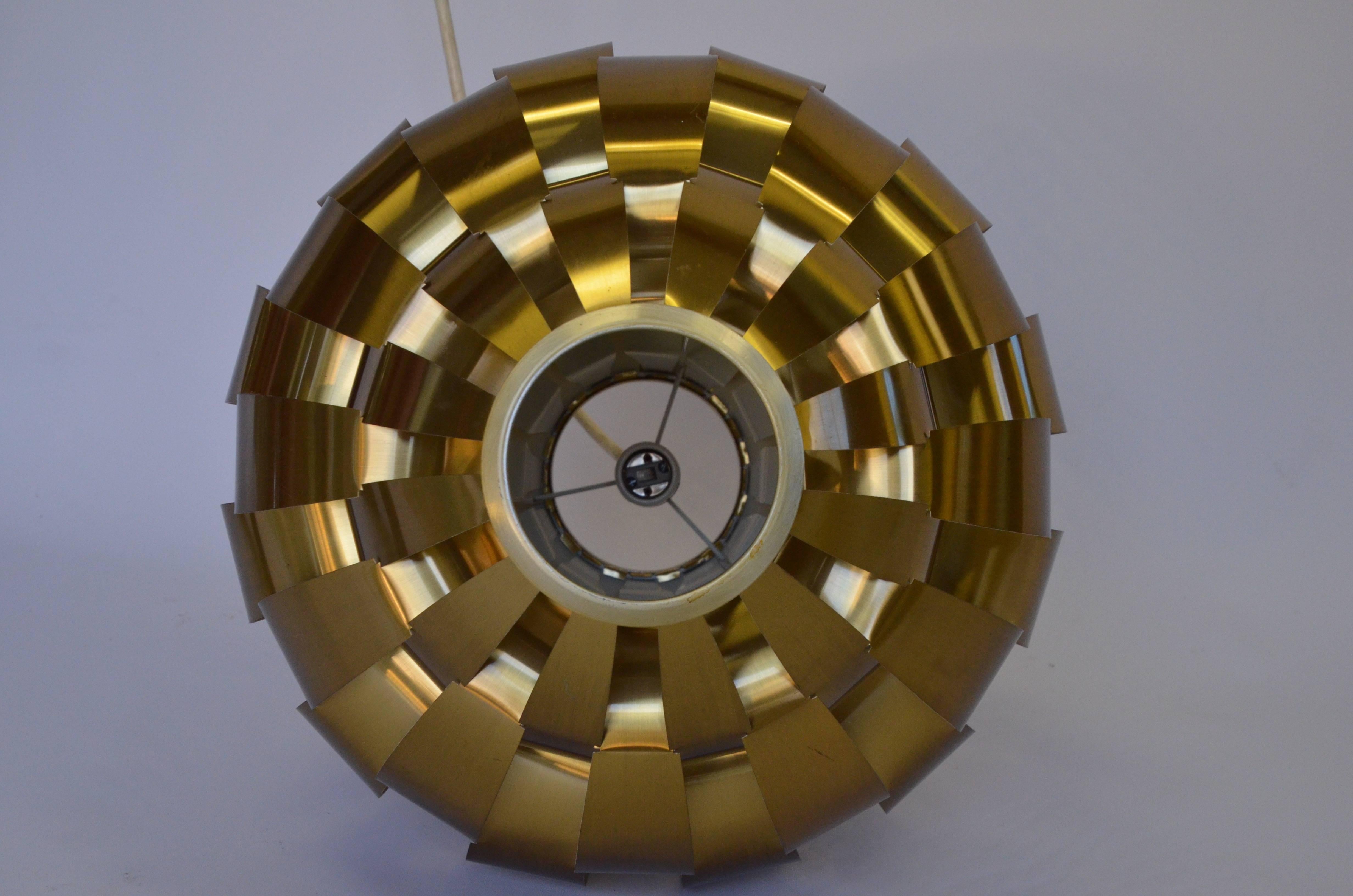 Lightolier brass ribbon pendant. The brushed brass chandelier is woven in a spherical shape. Measuring 16