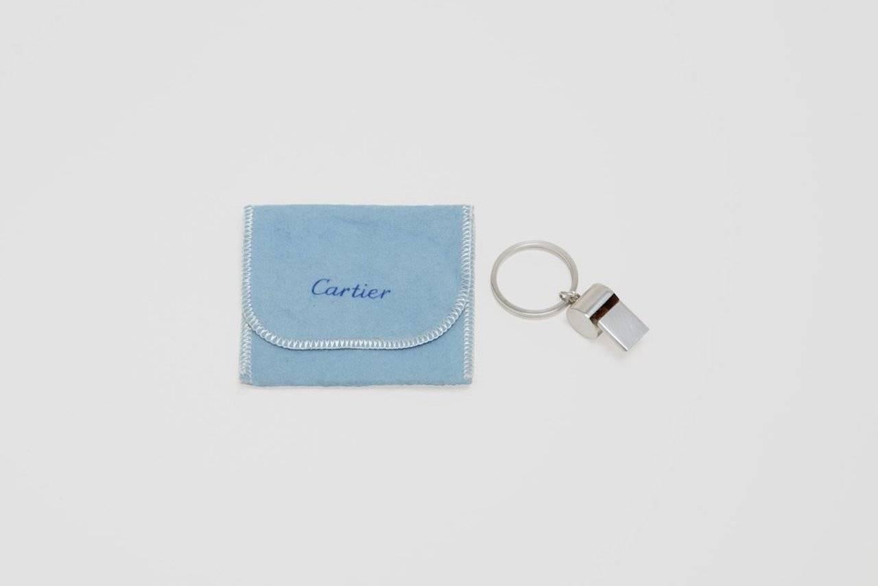 A sterling silver key chain with whistle. This novel key chain is very well made, and shows no signs of being used. The key chain comes in its original Cartier signed felt pouch. Signed 'Cartier' and 'Sterling' and dates circa 1980s.