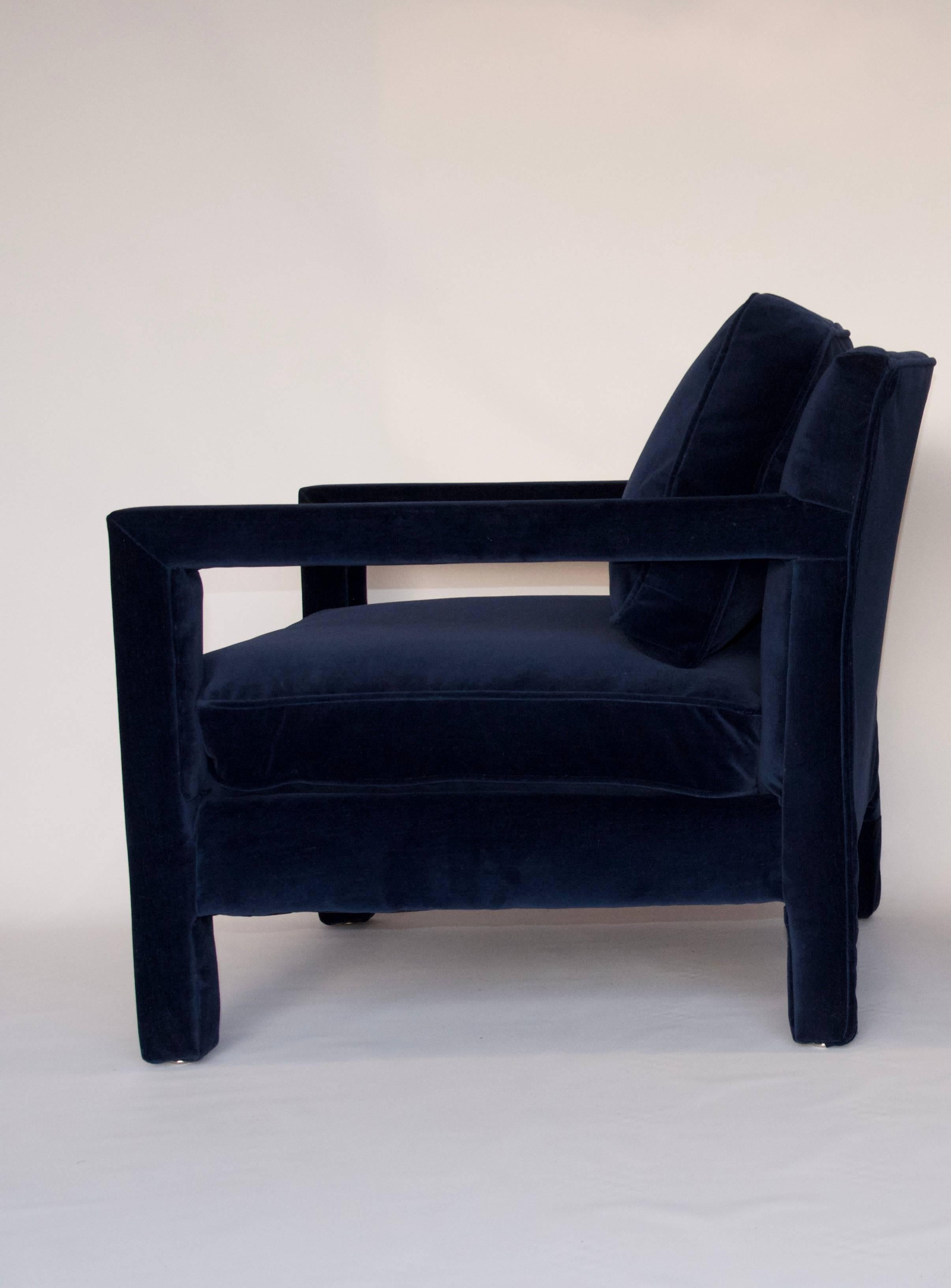 This fully upholstered Parsons style chair was made in the style of Milo Baughman by Bernhardt. The chair has been newly upholstered in a high quality blue velvet. Both the back and seat cushions are removable. Extremely comfortable and in excellent