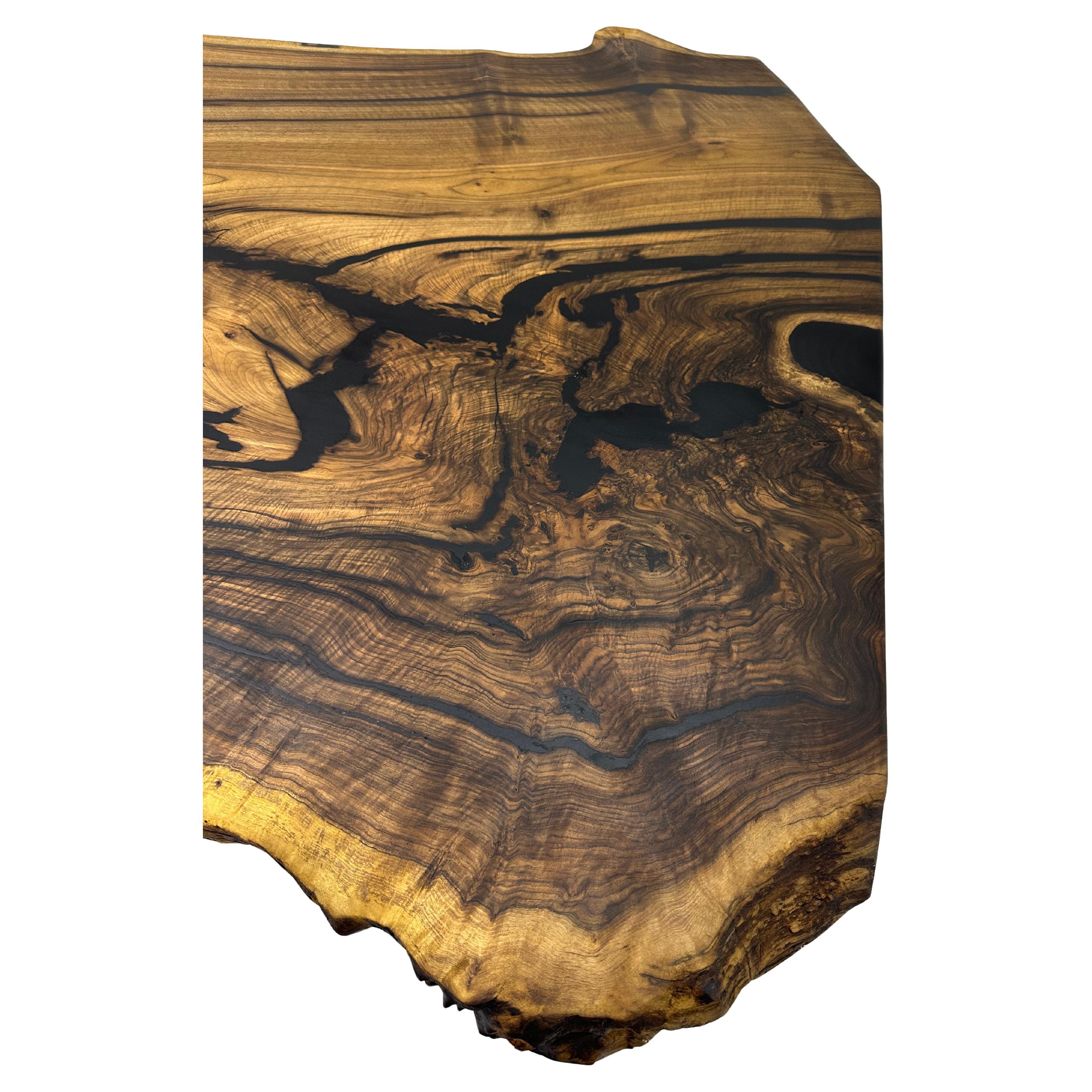 LIVE EDGE WALNUT DINING TABLE - ONE PIECE WALNUT TABLE

This table is made of natural walnut slabs. 

Some Walnut slabs have a lot of natural beauty as it’s one side has a large curve. This is one of them! 

We've filled the cracks with black epoxy,