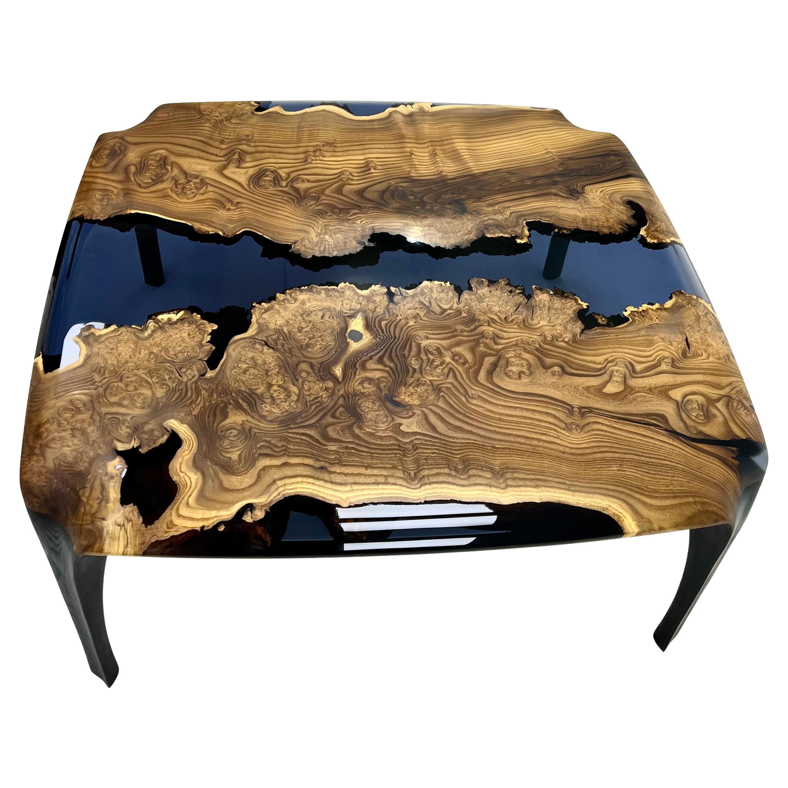 Epoxy Coffee Table

Handcrafted by skilled artisans, this coffee table seamlessly fuses natural wood with smoke epoxy resin, creating a captivating piece that captures nature's beauty. 
Its exceptional design and craftsmanship make it a centerpiece
