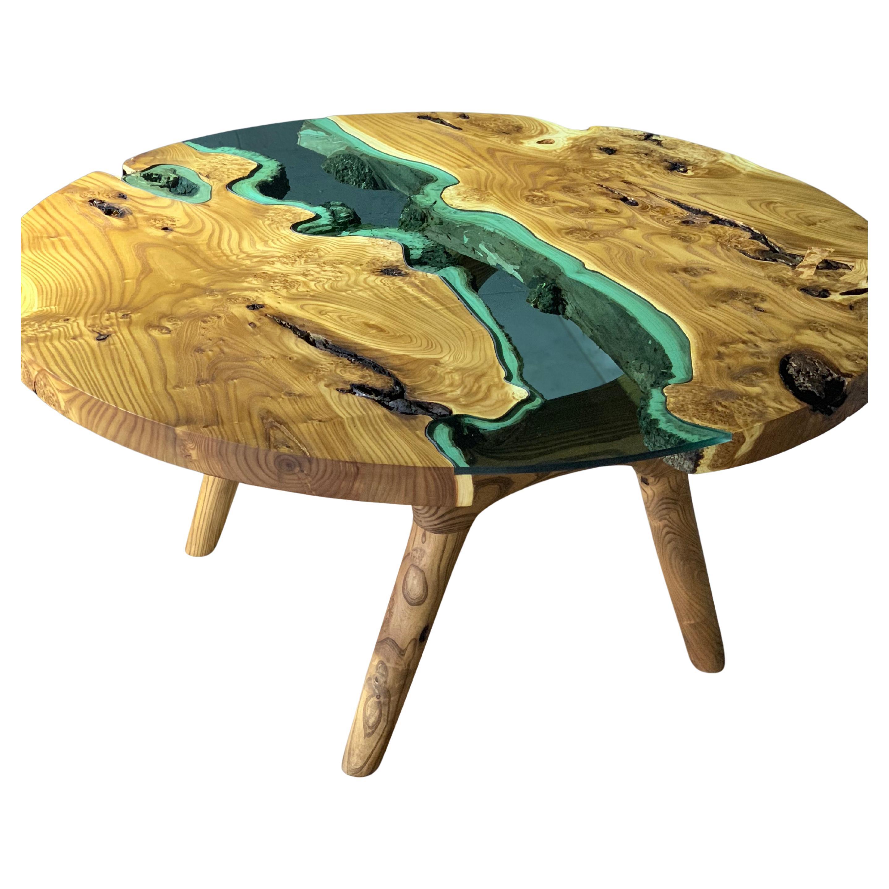 This wooden round coffee table is made from high-quality olaester wood, known for its warm color and beautiful textures.

The smooth, polished surface invites you to touch and appreciate the wood's natural beauty. Our Round Walnut Wood Coffee Table