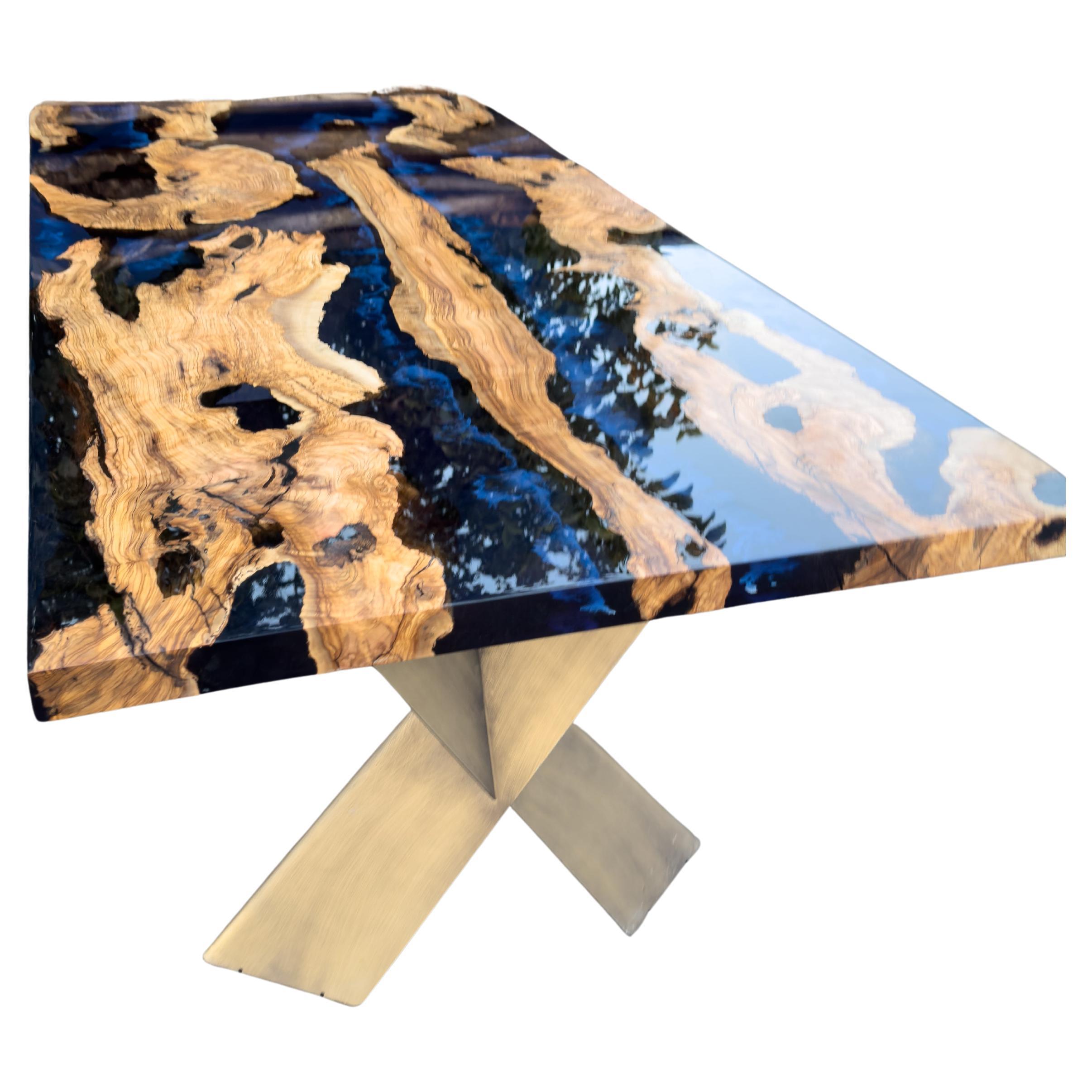 Custom Olive Epoxy Resin Dining Table  - Live Edge Wood Table

This stunning table is made of Mediterranean Olive wood. The unique beauty of the natural curves of olive wood combined with blue epoxy is seen in this table.

All woods have its own