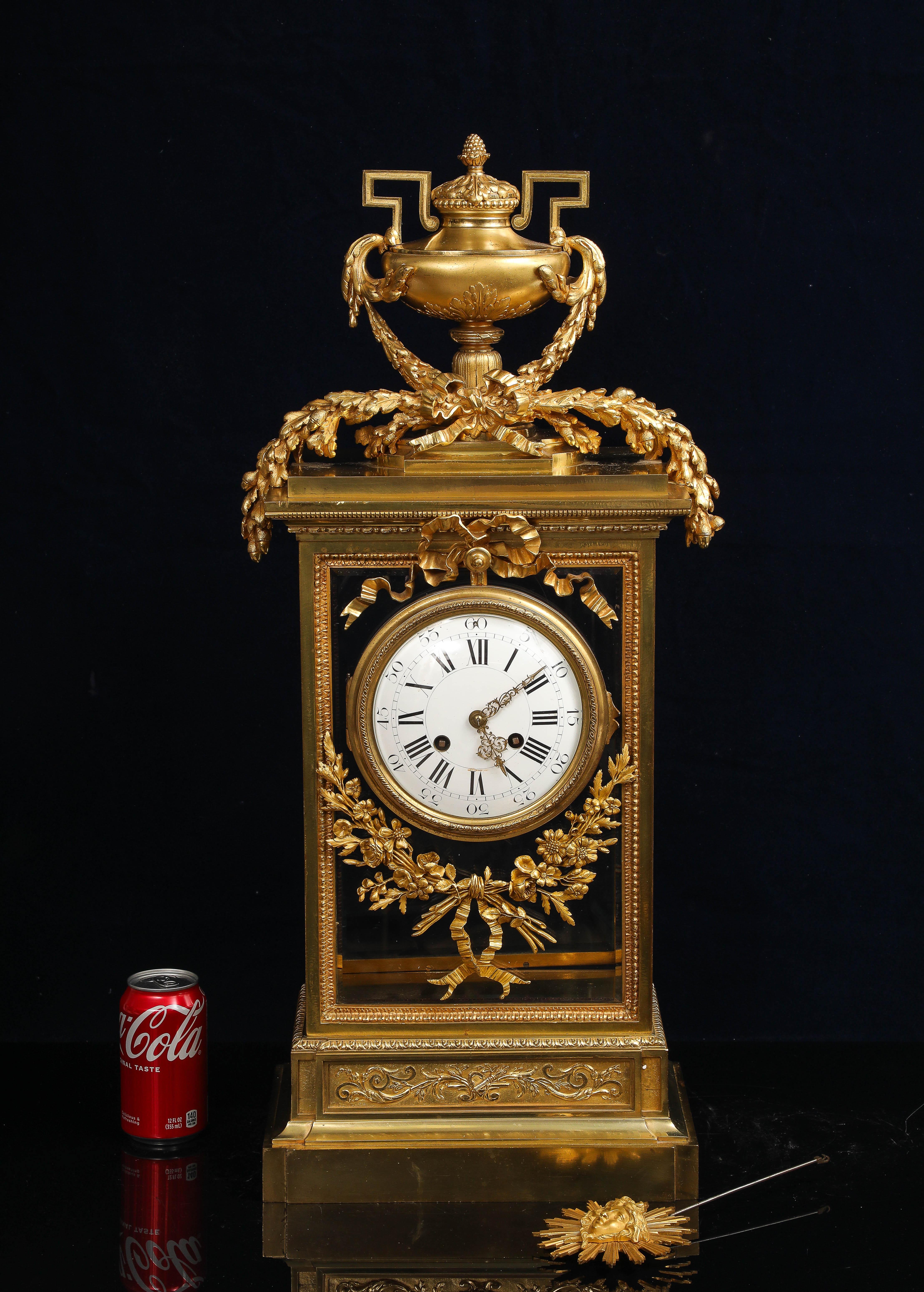 This monumental 19th-century French mantel clock, crafted in the lavish Louis XIV style, is a commanding expression of regal elegance and technical refinement. Towering in presence, it is constructed from richly gilded bronze and finely cut glass,