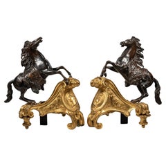 Paire de chenets patinés et montés en bronze doré, d'après Jacques Caffieri.