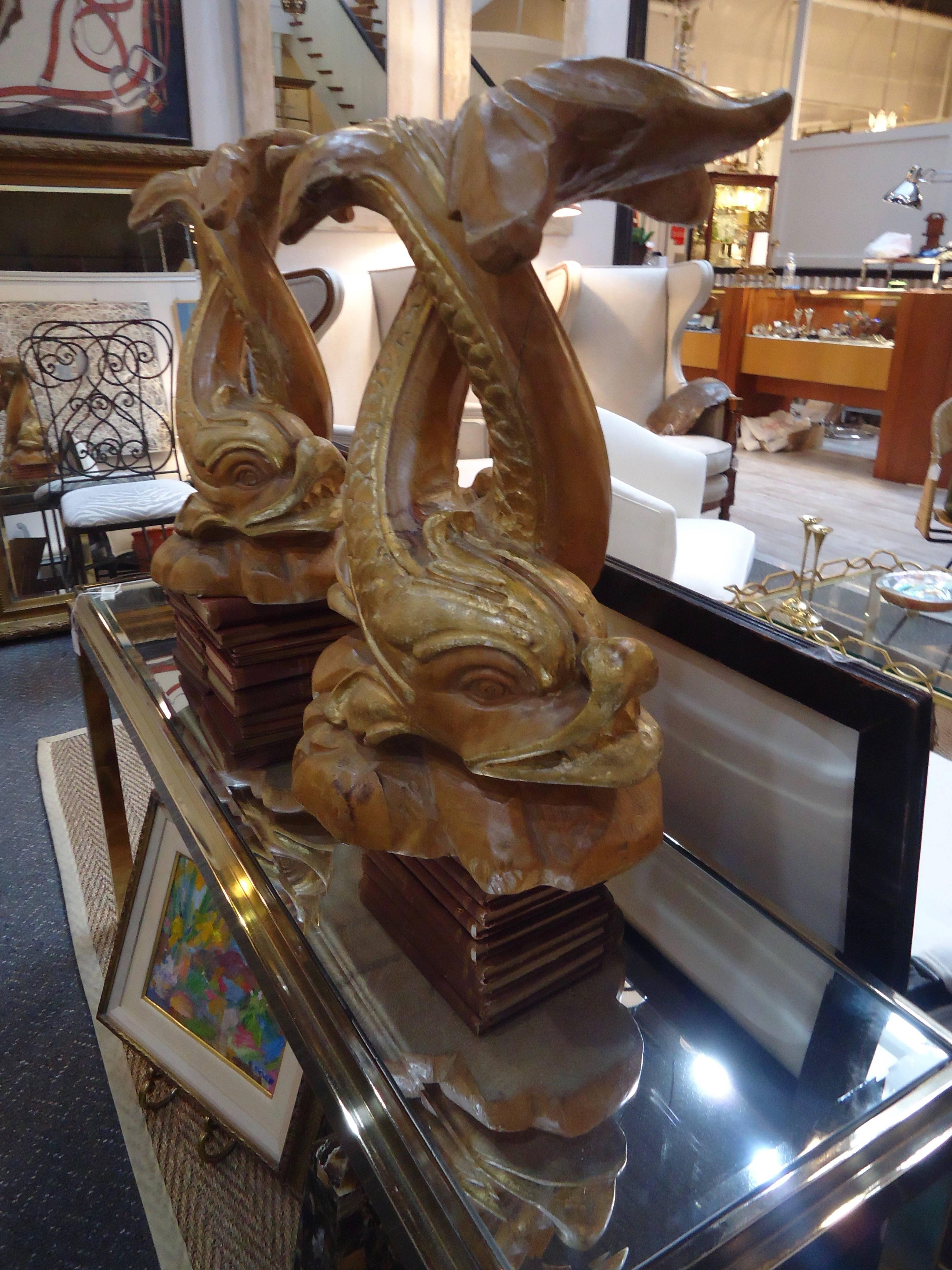 Very glamorous Palm Beachy pair of Chinese style dolphins in carved and gilded wood.