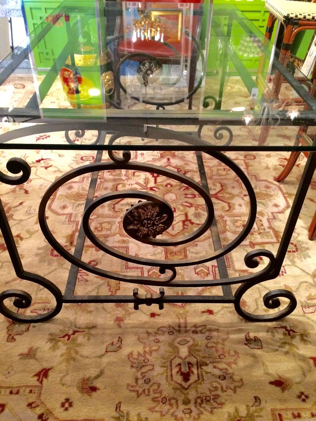 Fabulous dark brown antique wrought iron table base with curliecues and decorative rosette medallions on the sides and gold highlights. Glass top is 60" x 34.5" x 2" but table base could handle a much larger piece of glass or