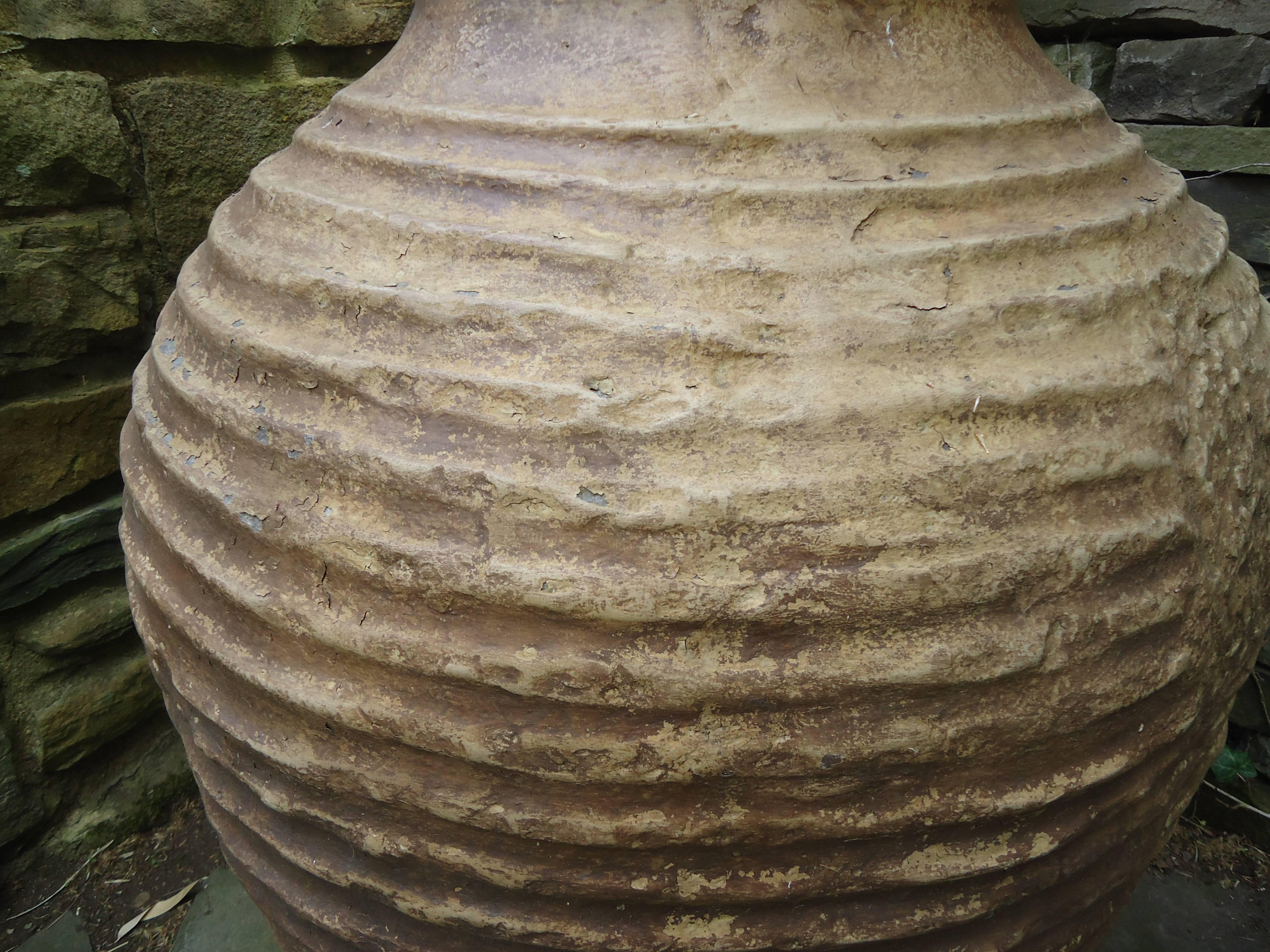 Large fiberglass resin Cretan urn hand cast from the original antique urn, having intricate details and a rich weathered clay hand-painted faux finish. This high quality medium is impervious to weather, durable and maintenance free. It’s also very