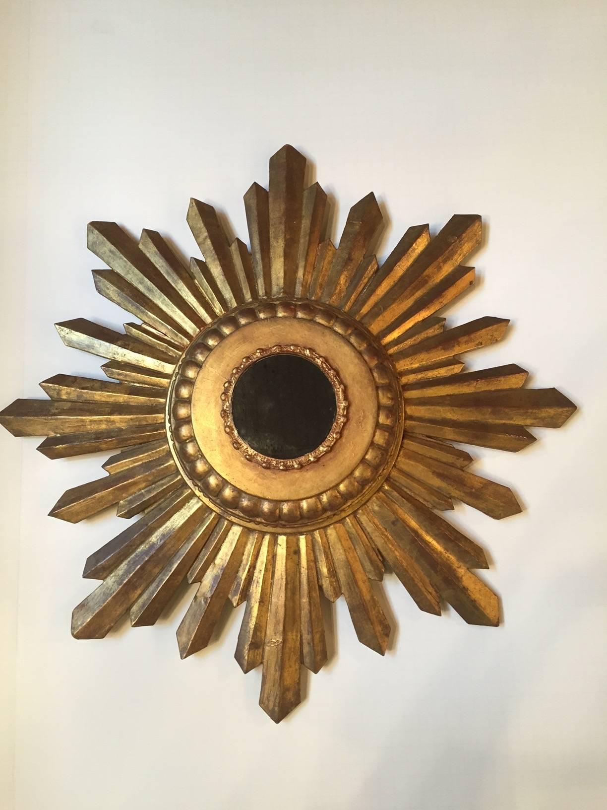 Wonderful gem of a starburst mirror in real giltwood with round aged mirror and 