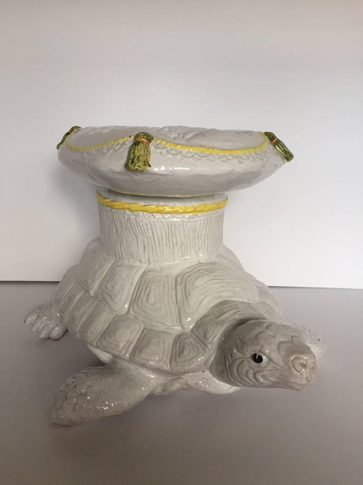 Unusual form for a vintage garden seat in the shape of a turtle with tufted pillow top, all in cream ceramic with yellow, gold and green details. Makes a whimsical extra seat or glamorous drinks table.