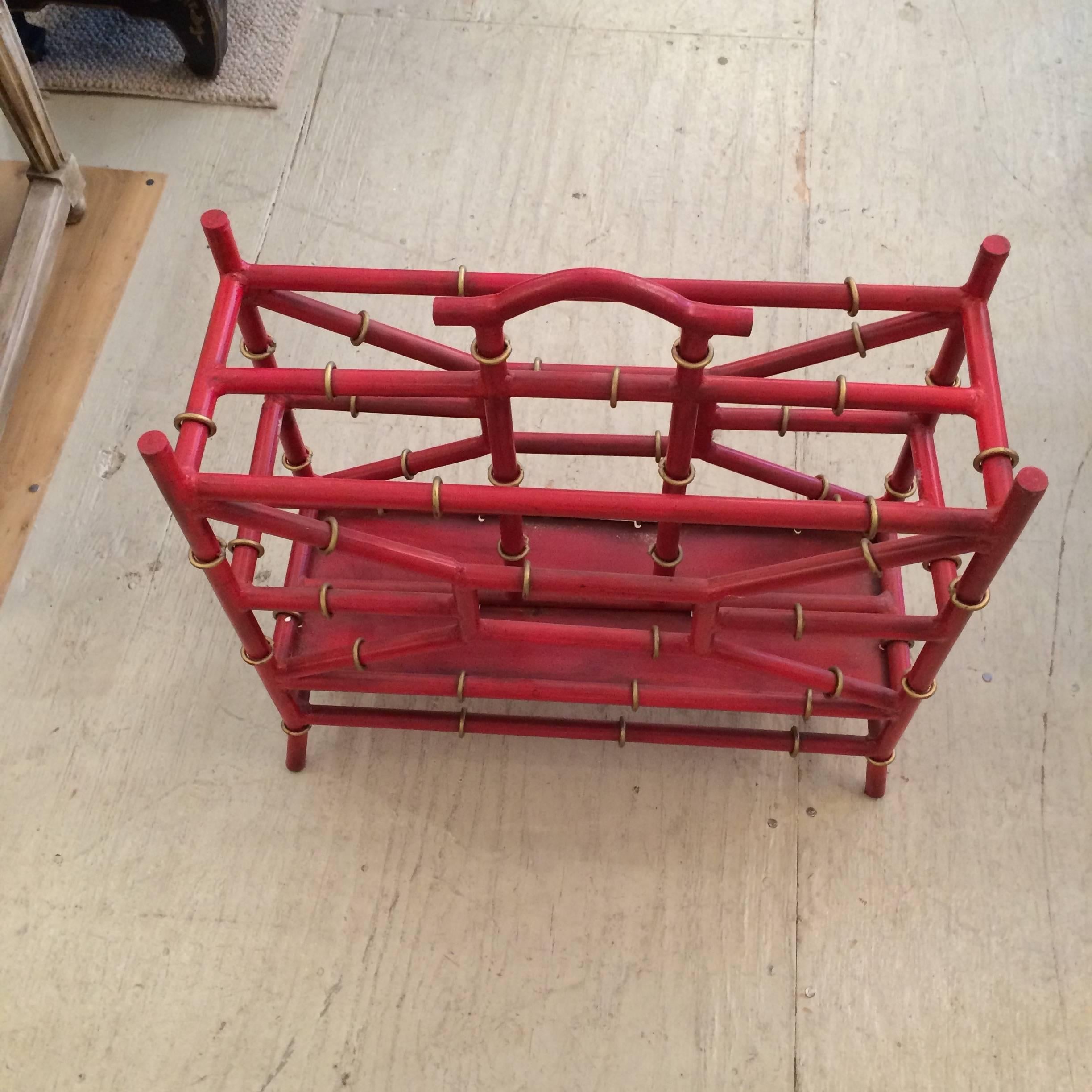 Fabulous magazine rack in bright coral red faux bamboo metal with gold detailing.
