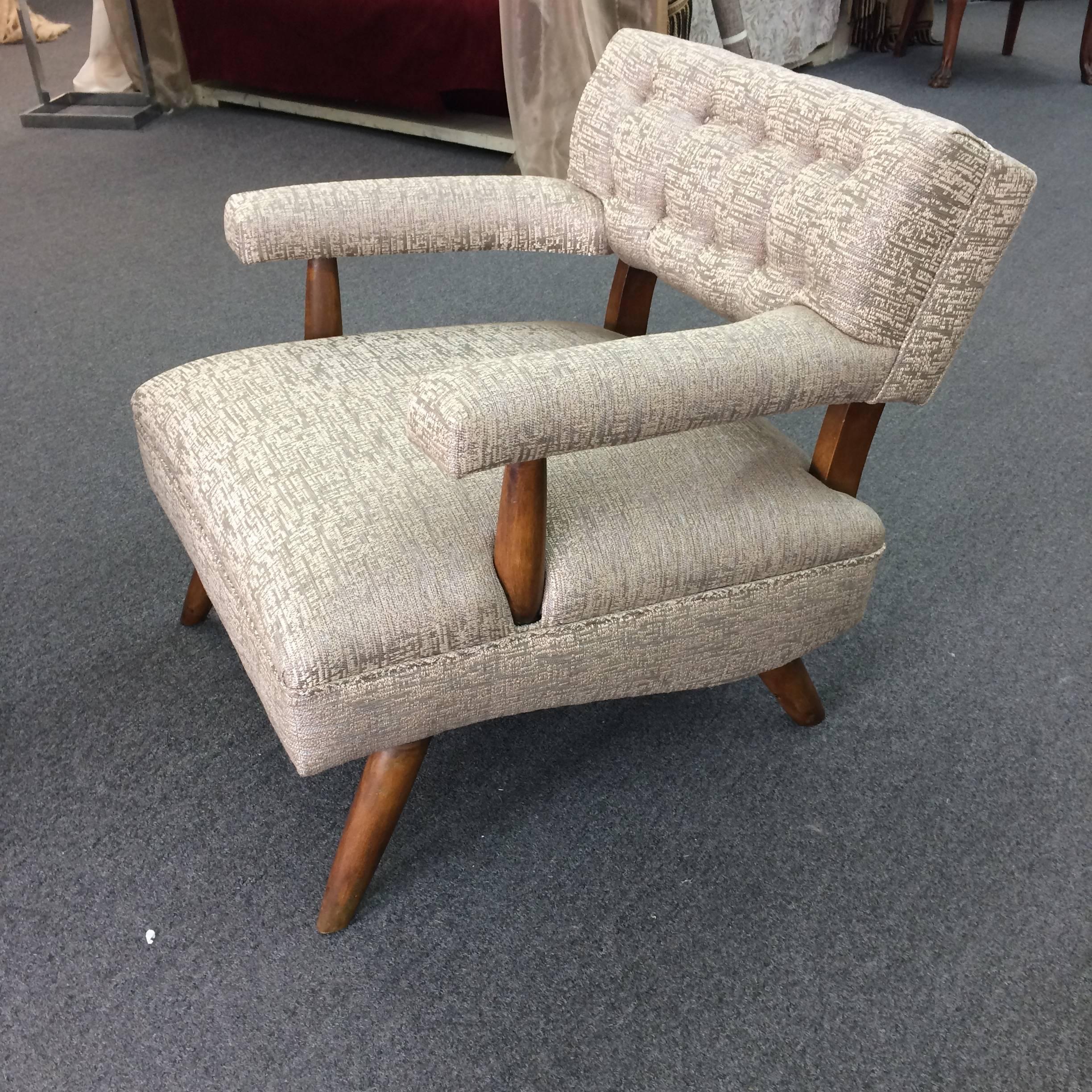 Wonderful Danish design armchair with contemporary tapered legs that splay outward, completely redone in era appropriate weave fabric in a neutral greyish taupe.