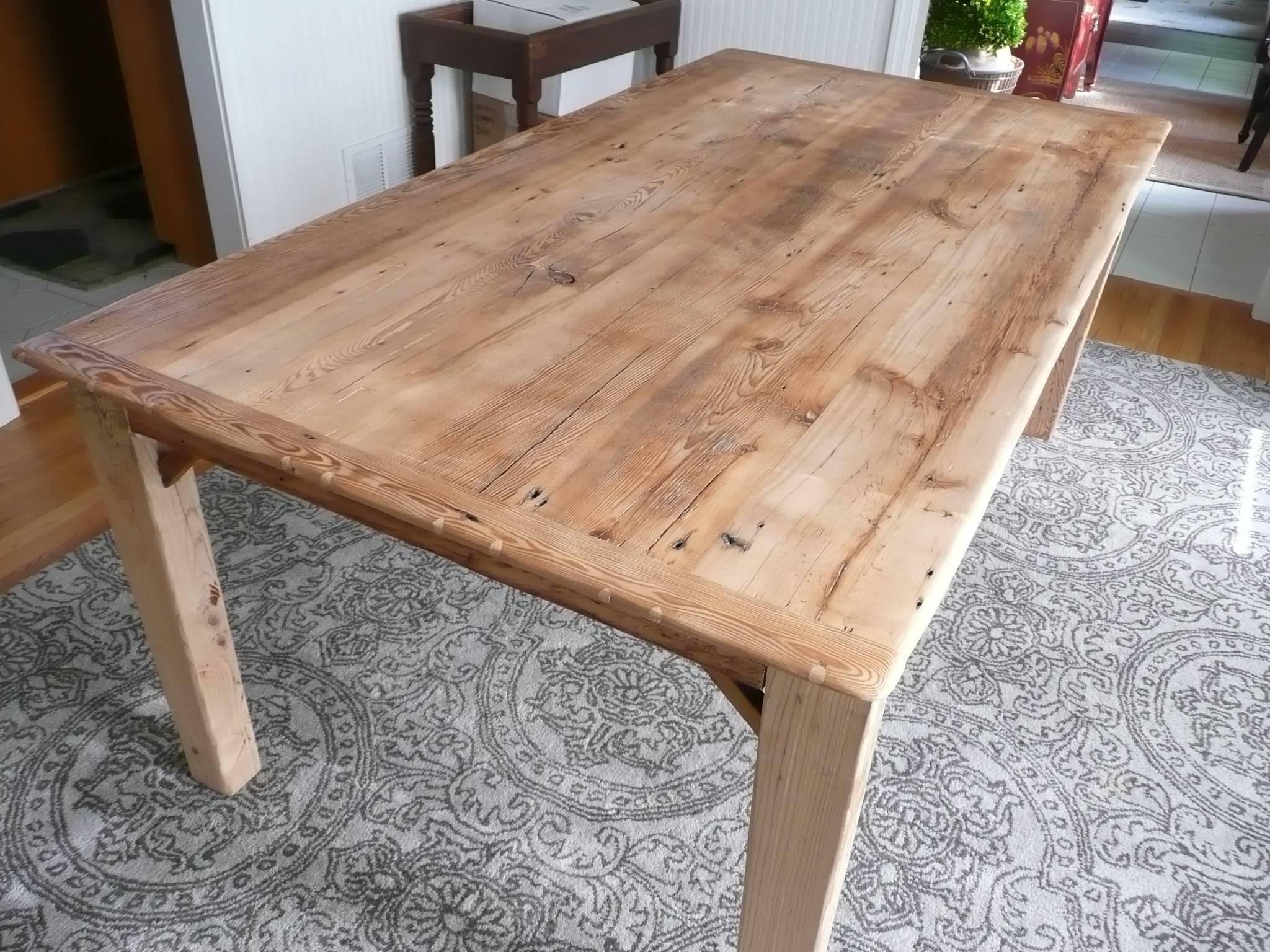 Beautiful 100 year old Vermont reclaimed barnwood is expertly crafted into a large natural color rectangular farm table with solid wood tapered legs from same source, having rubbed paste wax finish.