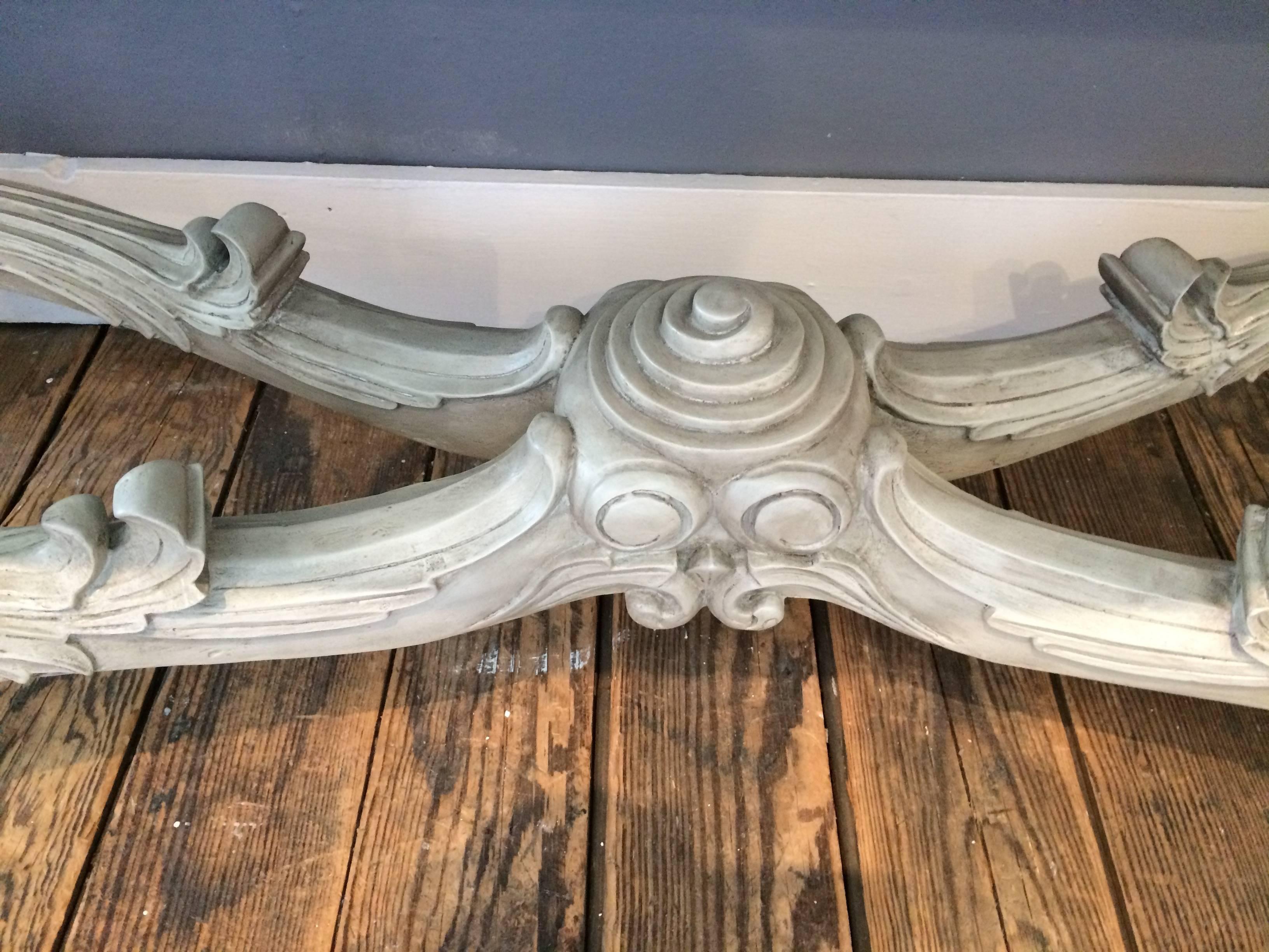 Stylish contemporary console made by Oly Studio with a romantic ornately hand-carved grey painted base with intricate scroll motifs, and an aged mirror top.

SC