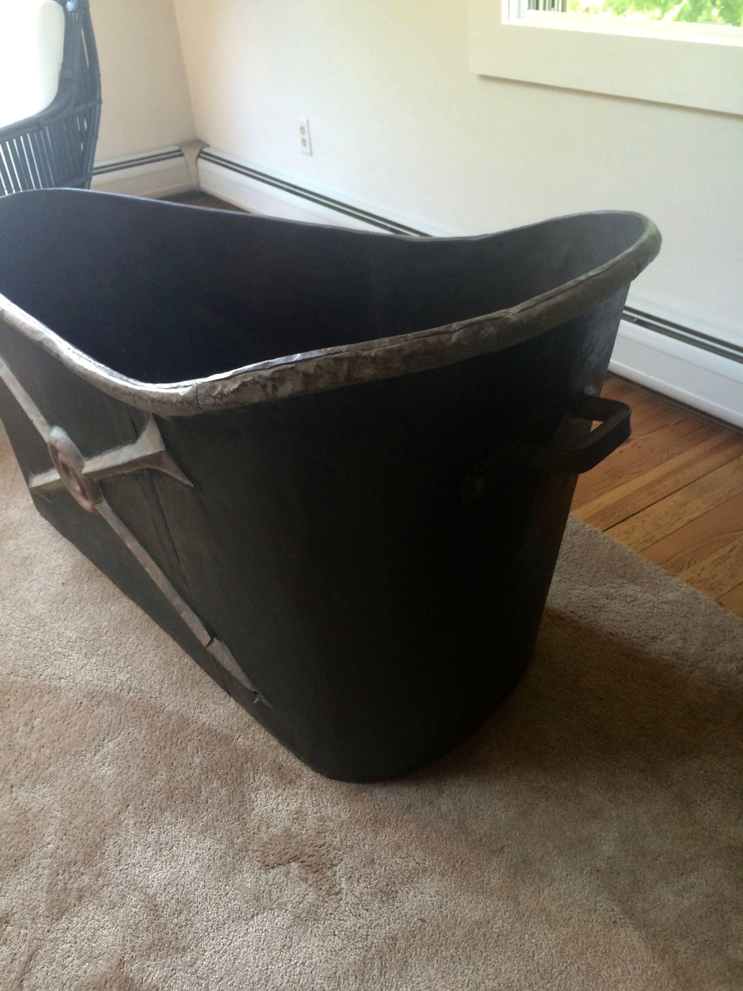 Rare French neoclassical bathtub from the mid-1800s having handsome decorative arrows in relief and handles at both ends as well as a drain hole.
 