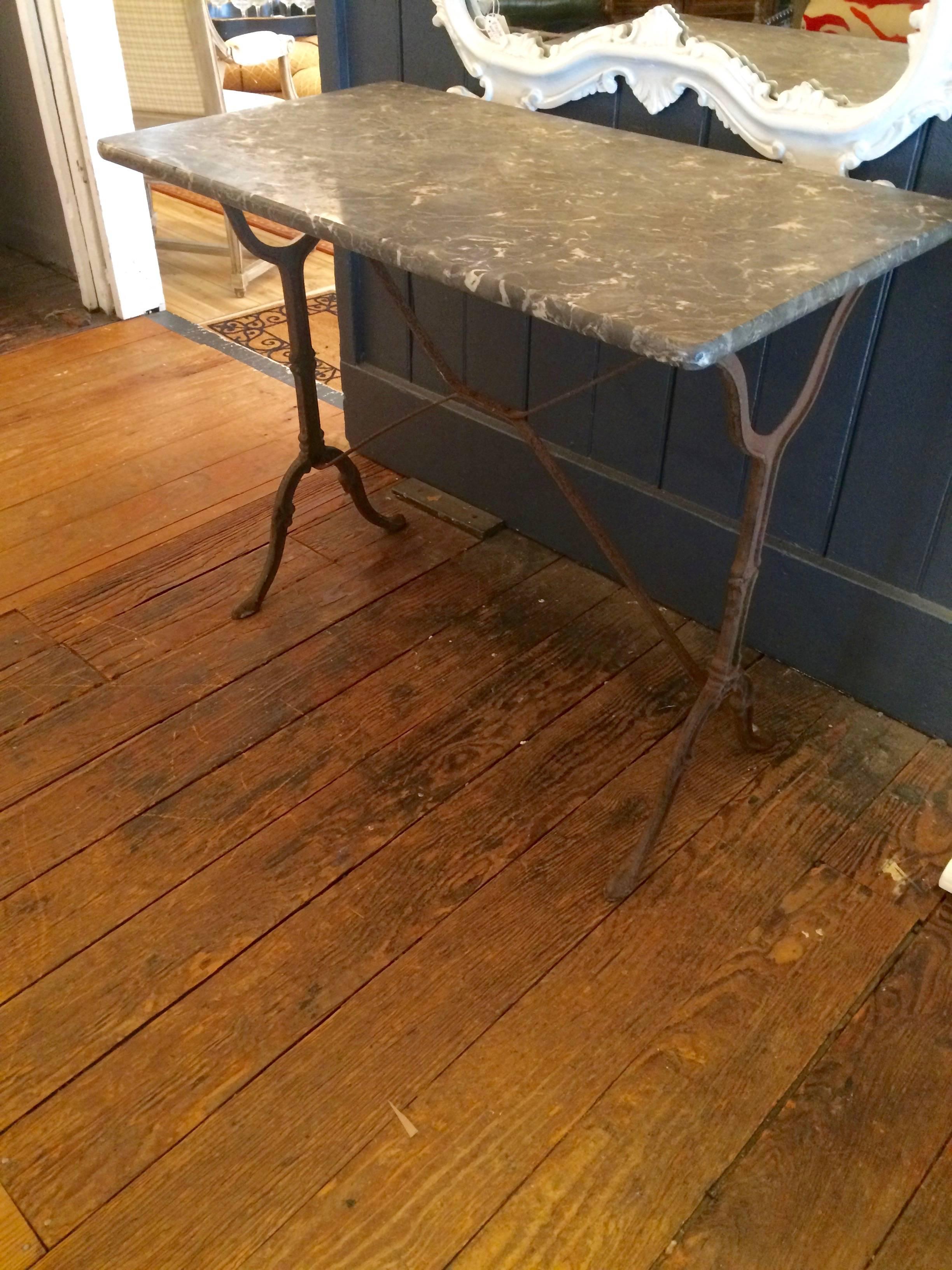 Darling rectangular vintage French bistro table or desk, having an old rust colored wrought iron base and elegant grey and cream marble writing or eating surface.

Note: Many other imported vintage bistro tables available.

FL