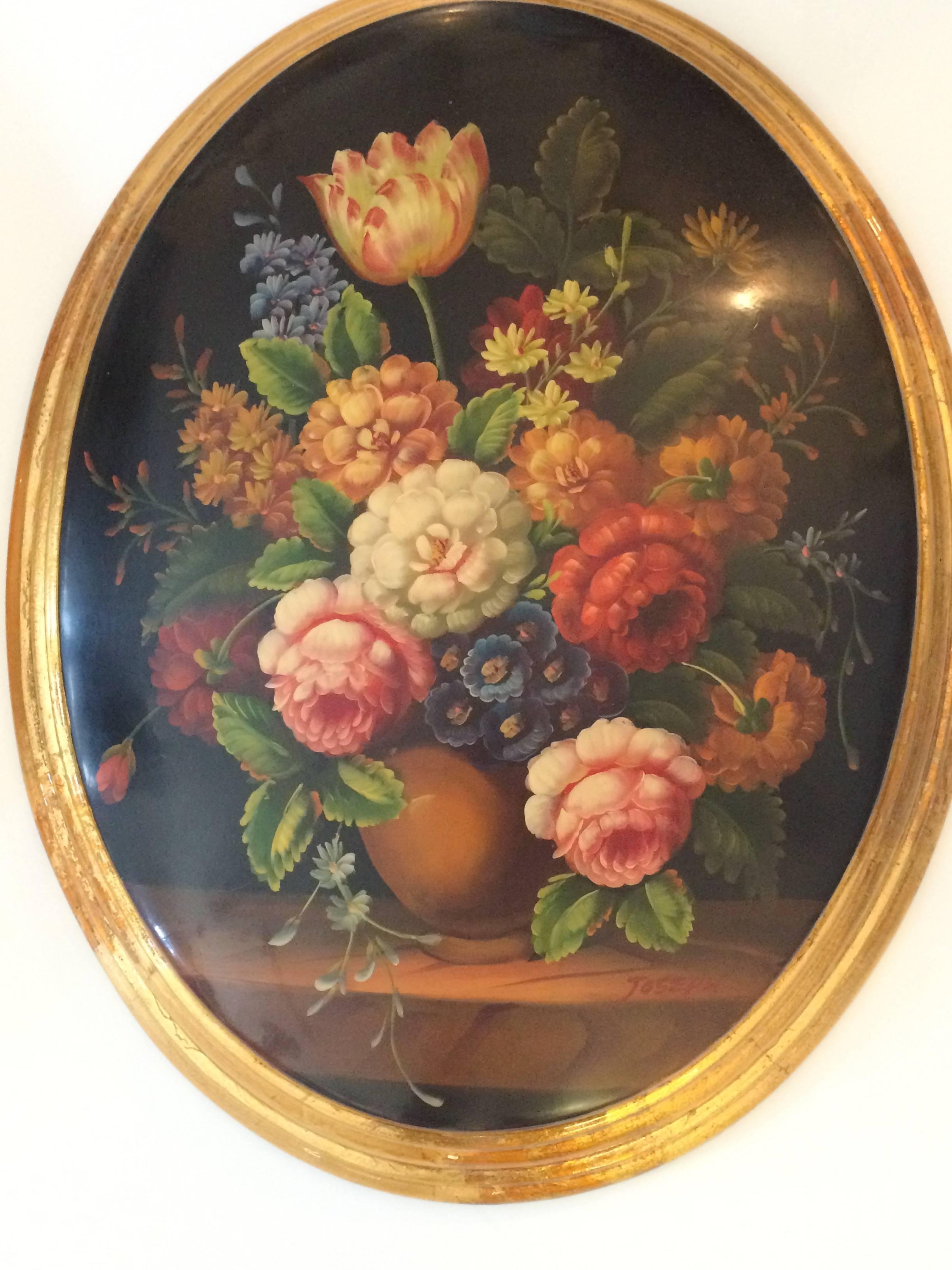 Old world charming floral still life paintings rendered on oval convex wood, lacquered and framed in gilded moldings. Decorative bow hangers are included.