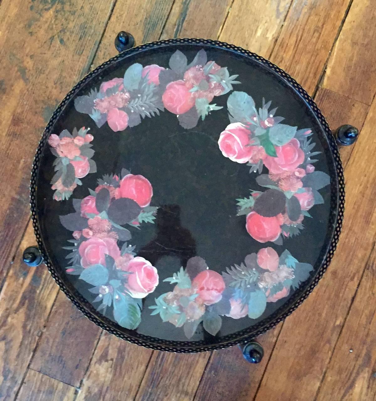 Pretty side table having two trays with soft pink and green floral decoration.
