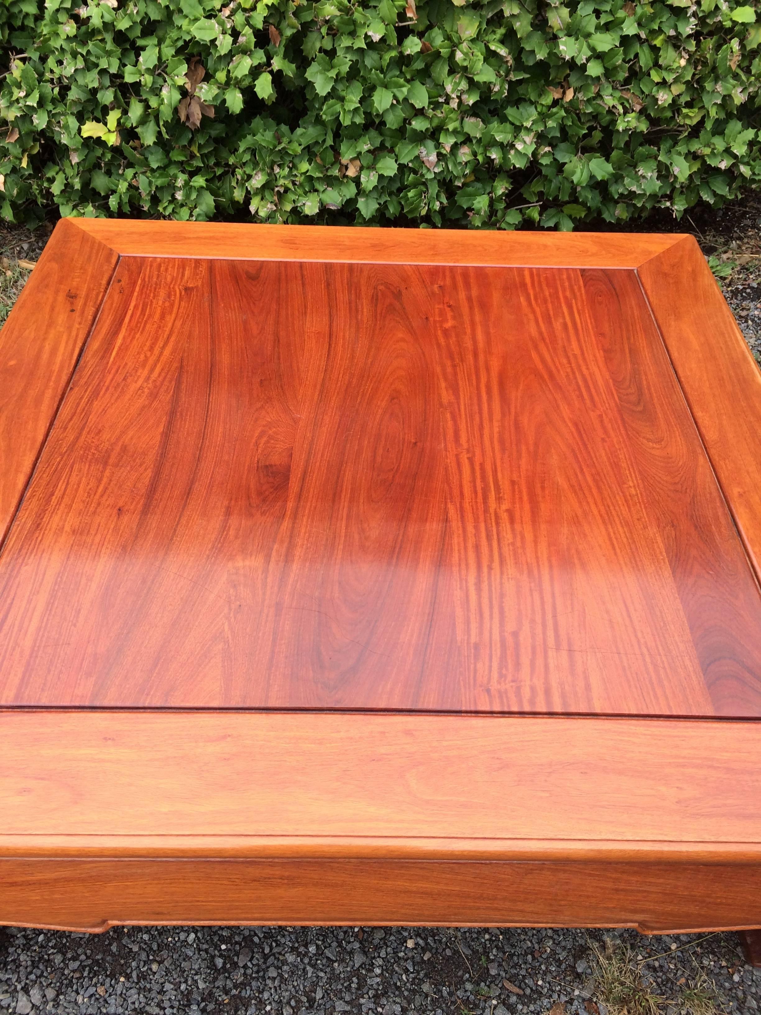 Chinese style large mahogany coffee table with gorgeous grain on top and stylish Asian motife legs.