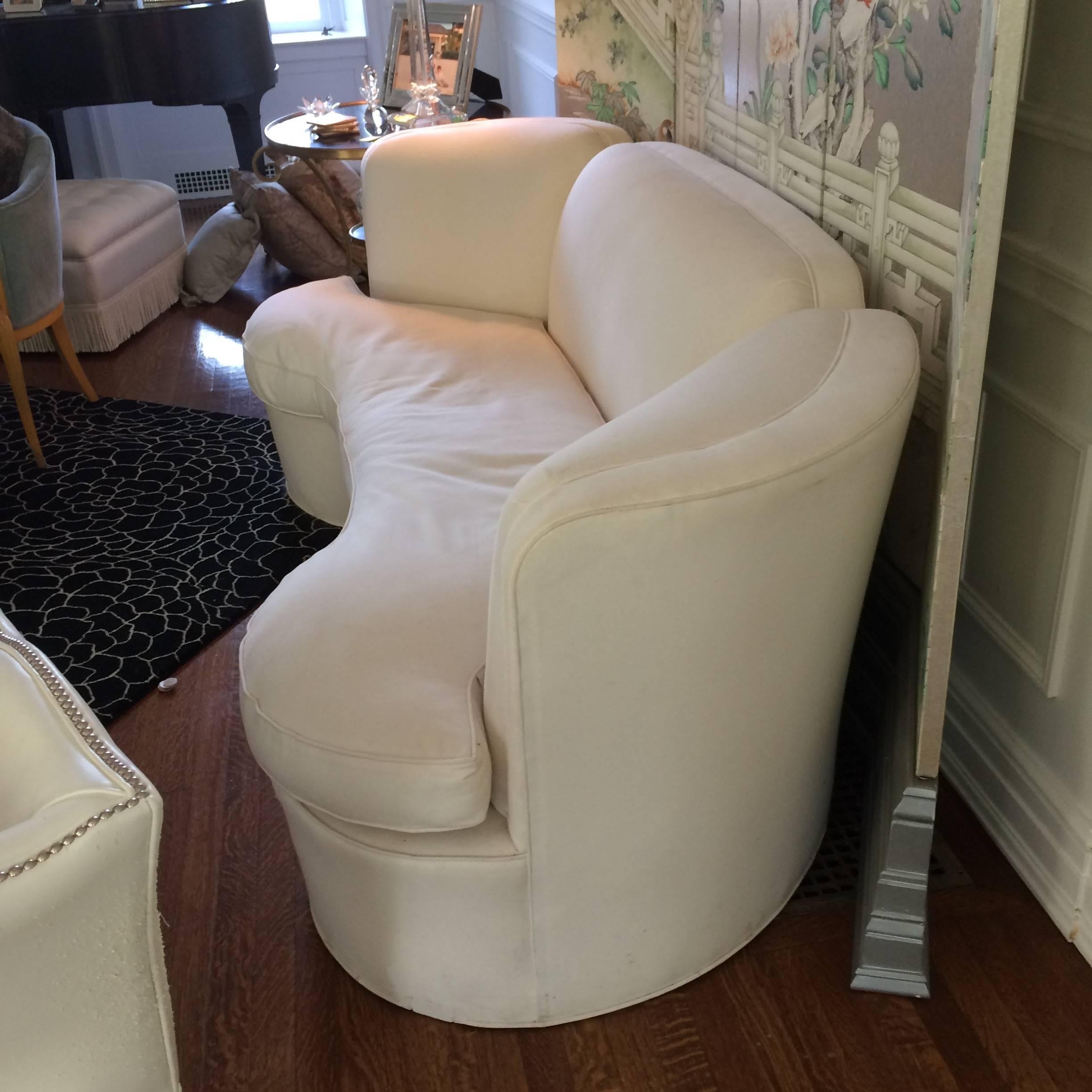 Stylish vintage sofa with wonderful curved silouette, single unattached seat cushion, beautiful from front and back. Updated in heavy white duck upholstery, but dirty. May need reupholster if stain on front doesn't come out.