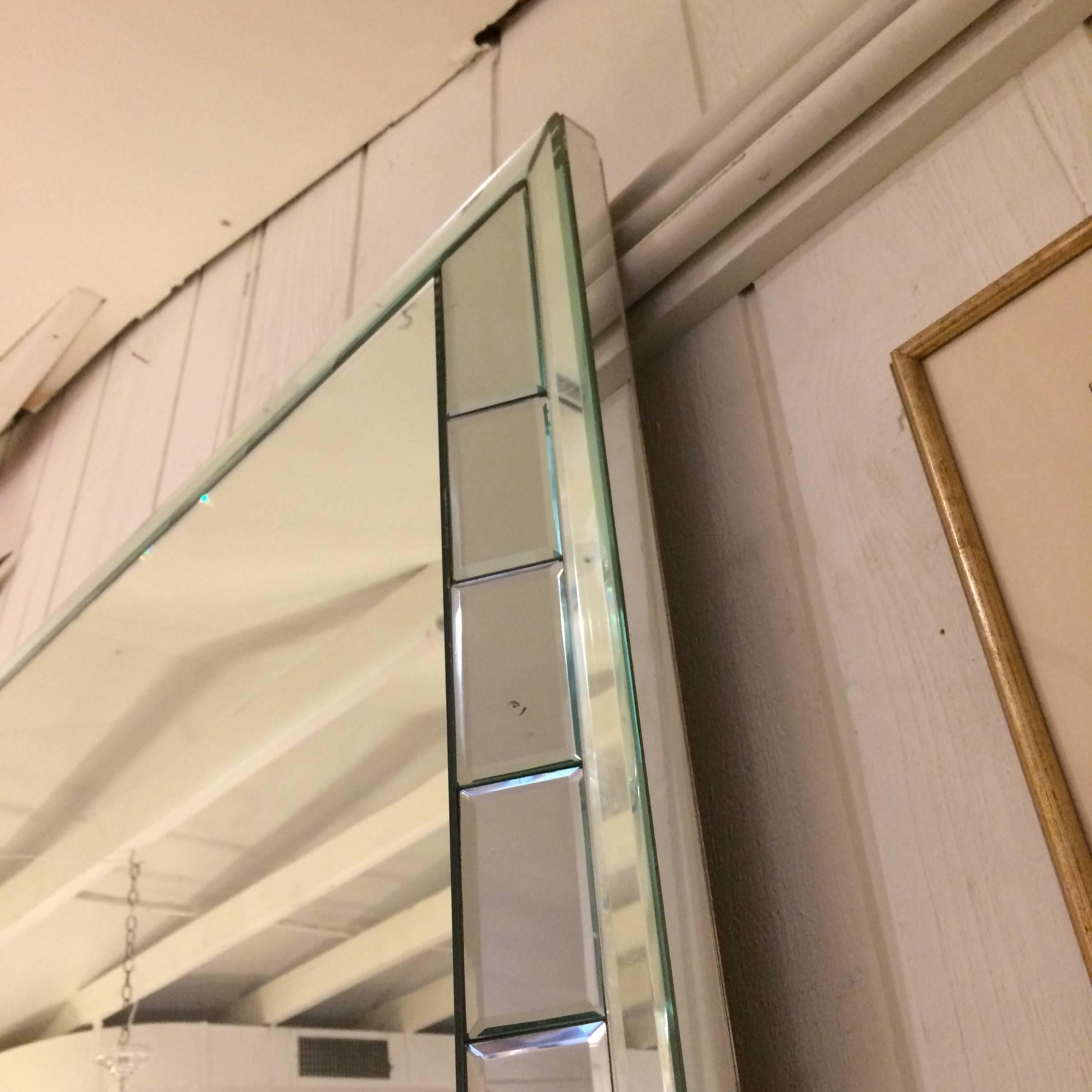 Very large impressive Mid-Century modern rectangular mirror having smaller bevelled rectangles around the periphery and a three dimensional silouette, with 5